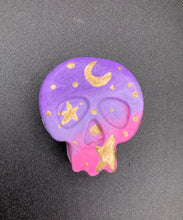 Load image into Gallery viewer, Ideal magnet design to adorn your refrigerator, lockers, workstation, toolbox, or dishwasher. This unique skull statuette features intricate details and vibrant colors, inspired by the summer sky at sundown. Variations in color from purple to light pink simulate the dramatic ombre seen in a setting sun, completed with golden stars and moon silhouettes for a celestial touch. H 1 1/2” x W 1 1/2” x D 3/4”