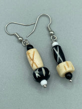 Load image into Gallery viewer, This set of earrings is crafted from a mix of bone and wood carved beads, giving it an eye-catching, one-of-a-kind look. It's versatile enough to dress up or down, making it a great choice for any occasion. Measurements: 1 1/2 ” in length