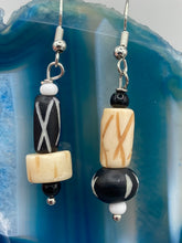 Load image into Gallery viewer, This set of earrings is crafted from a mix of bone and wood carved beads, giving it an eye-catching, one-of-a-kind look. It's versatile enough to dress up or down, making it a great choice for any occasion. Measurements: 1 1/2 ” in length