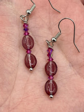 Load image into Gallery viewer, These delicate earrings feature light purple and tiny fuchsia glass beads, which offer a range of beautiful hues, such as blue, green, pink and gold. With a versatile style, these earrings will enhance any ensemble.  Measurements: 1 1/2” in length