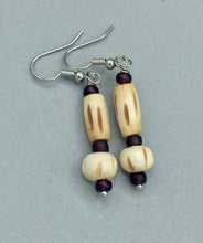 Load image into Gallery viewer, This classic set of earrings is crafted with a combination of cylindrical and round bone beads and dark burgundy glass beads. Offering subtle versatility with its neutral colors, it can easily dress up or dress down any look for a distinct, unique style.  Measurements: 1 5/8 ” in length