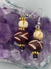 Load image into Gallery viewer, Crafted with large and small round bone beads, these gold-tone floral metal bead earrings come in a range of neutral colors. Their versatile design allows them to transition easily from casual to formal, offering a unique edge to any ensemble. Measurements: 1 1/2 ” in length