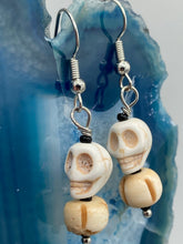 Load image into Gallery viewer, These handcrafted Mini Howlite Skull Bead and Bone Carved Bead Earrings will give any goth, emo, or witchy outfit an extra special touch. Perfect for Day of the Dead celebrations or any casual occasion, these unique earrings will make any look stand out. Measurements: 1 1/4 ” in length