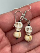 Load image into Gallery viewer, These handcrafted Mini Howlite Skull Bead and Bone Carved Bead Earrings will give any goth, emo, or witchy outfit an extra special touch. Perfect for Day of the Dead celebrations or any casual occasion, these unique earrings will make any look stand out. Measurements: 1 1/4 ” in length