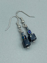 Load image into Gallery viewer, These eye-catching earrings feature a unique combination of large square-shaped black obsidian beads and two small square hematite beads, drawing inspiration from nature to give you a bohemian, hippie vibe. Perfect for a shabby chic, boho chic look. Measurements: 1” in length