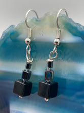 Load image into Gallery viewer, These eye-catching earrings feature a unique combination of large square-shaped black obsidian beads and two small square hematite beads, drawing inspiration from nature to give you a bohemian, hippie vibe. Perfect for a shabby chic, boho chic look. Measurements: 1” in length