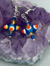 Load image into Gallery viewer, Vibrant color bumpy round lampworked glass bead set of earrings. Colorful teal, white, yellow, and bright orange festive piñata shaped bead.  This also reminds me of the shape of a virus. Either way, this is a super fun, unique, bold piece of jewelry, it's sure to make a statement piece.  Measurements: 1” in length