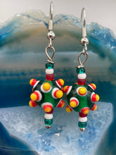 Load image into Gallery viewer, Vibrant color bumpy round lampworked glass bead set of earrings. Colorful green, white, red, and bright yellow festive piñata shaped bead.  This also reminds me of the shape of a virus. Either way, this is a super fun, unique, bold piece of jewelry, it's sure to make a statement piece.  Measurements: 1 1/4” in length
