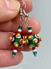 Load image into Gallery viewer, Vibrant color bumpy round lampworked glass bead set of earrings. Colorful green, white, red, and bright yellow festive piñata shaped bead.  This also reminds me of the shape of a virus. Either way, this is a super fun, unique, bold piece of jewelry, it's sure to make a statement piece.  Measurements: 1 1/4” in length