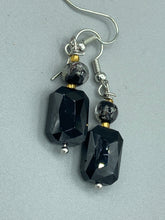 Load image into Gallery viewer, Elegantly crafted from black rectangular and circular glass beads, these dainty earrings offer a versatile style that can effortlessly elevate any ensemble.  Measurements: 1 3/8” in length