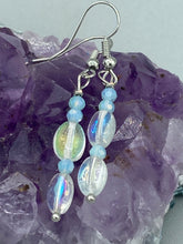Load image into Gallery viewer, Elevate your style with these simple yet dainty beaded earrings boasting a gentle iridescent and frosty light blue hue. Perfectly versatile, they will add a refined touch to any outfit.  Measurements: 1 1/4” in length