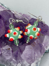 Load image into Gallery viewer, Vibrant color bumpy round lampworked glass bead set of earrings. Colorful light green, white, yellow, and bright red festive piñata shaped bead.  This also reminds me of the shape of a virus. Either way, this is a super fun, unique, bold piece of jewelry, it's sure to make a statement piece.  Measurements: 1 1/4” in length