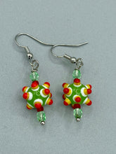 Load image into Gallery viewer, Vibrant, bumpy round lampworked glass beaded earrings in an array of colors including light green, white, yellow, dark red and bright orange. The fiesta piñata-shaped bead invokes a festive vibe, while its unique virus-shaped design promotes a bold statement. An eye-catching and unique piece of jewelry sure to turn heads. Measurements: 1 1/4” in length