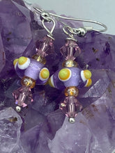 Load image into Gallery viewer, Marvel at the vivid colored bumpy round lampworked glass beads in this earring set, ranging from soft purple to yellow and white. Get creative and imagine the fiesta piñata-shaped bead as a virus for a unique, one-of-a-kind look. Crafted with care and full of personality, this jewelry will be sure to make a statement. Measurements: 1 1/4” in length