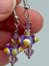 Load image into Gallery viewer, Marvel at the vivid colored bumpy round lampworked glass beads in this earring set, ranging from soft purple to yellow and white. Get creative and imagine the fiesta piñata-shaped bead as a virus for a unique, one-of-a-kind look. Crafted with care and full of personality, this jewelry will be sure to make a statement. Measurements: 1 1/4” in length