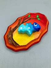 Load image into Gallery viewer, Starry Night Mini Bat Wall Art Decor. A perfect hanging art piece to add a pop of color to your wall, next to your display of crystals or witchy altar. Bat figurine is made of polymer clay, painted ombre colors from light to dark with white stars and crescent moon flying over the sun rise sky. Orange and red wood frame matches the light yellow, orange and red sky. Art come ready to hang with a sawtooth hangers on back. Measurements: H 3" x W 5” x D 1 1/2"