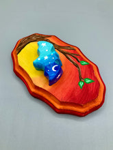 Load image into Gallery viewer, Starry Night Mini Bat Wall Art Decor. A perfect hanging art piece to add a pop of color to your wall, next to your display of crystals or witchy altar. Bat figurine is made of polymer clay, painted ombre colors from light to dark with white stars and crescent moon flying over the sun rise sky. Orange and red wood frame matches the light yellow, orange and red sky. Art come ready to hang with a sawtooth hangers on back. Measurements: H 3" x W 5” x D 1 1/2"
