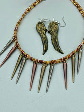 Load image into Gallery viewer, A copper-toned, adjustable Steampunk-style glass beaded necklace is detailed with sharp-drop metal plated hanging beads. Bright orange rectangular tube beads mix with other shapes for an eye-catching effect, while double-hole flat matte copper-toned beads provide a collar finish which makes this piece drape elegantly across the neck. Sparkling gold tone angel wings earrings made of polymer clay. These earrings are designed to face forward when worn instead of the front wings showing on the side.