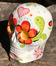 Load image into Gallery viewer, This Mini Floral Ceramic Sugar Skull pays homage to the Dia De Los Muertos tradition. Featuring a vibrant red and yellow flower inspired by a trip to the D.C. Arboretum, this piece of Day Of The Dead Skull Art is a wonderful way to honor those dearly departed. The perfect addition to any home. Measurements: H 2 3/4” x W 2” x D 2”