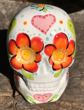 Load image into Gallery viewer, This Mini Floral Ceramic Sugar Skull pays homage to the Dia De Los Muertos tradition. Featuring a vibrant red and yellow flower inspired by a trip to the D.C. Arboretum, this piece of Day Of The Dead Skull Art is a wonderful way to honor those dearly departed. The perfect addition to any home. Measurements: H 2 3/4” x W 2” x D 2”