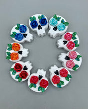 Load image into Gallery viewer, Cremation memorial art, such as Day of the Dead Spirit Pieces, provide a unique way to keep a loved one close to your heart. Handcrafted with care, each piece of artwork is specially tailored to the individual, providing a lasting reminder of those who are dearly missed. On altars and ofrendas, these pieces make a beautiful addition. Composed with meticulous attention to detail, these mini polymer clay skulls feature hand sculpted roses and leaves.