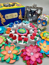 Load image into Gallery viewer, Cremation memorial art, such as Day of the Dead Spirit Pieces, provide a unique way to keep a loved one close to your heart. Handcrafted with care, each piece of artwork is specially tailored to the individual, providing a lasting reminder of those who are dearly missed. On altars and ofrendas, these pieces make a beautiful addition. Composed with meticulous attention to detail, these mini polymer clay skulls feature hand sculpted roses and leaves.