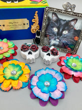 Load image into Gallery viewer, Cremation memorial art, such as Day of the Dead Spirit Pieces, provide a unique way to keep a loved one close to your heart. Handcrafted with care, each piece of artwork is specially tailored to the individual, providing a lasting reminder of those who are dearly missed. On altars and ofrendas, these pieces make a beautiful addition. Composed with meticulous attention to detail, these mini polymer clay skulls feature hand sculpted dark red roses and leaves. H 1 1/2” x W 1 1/2” x D 3/4”