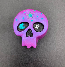 Load image into Gallery viewer, Inspired by nature, this skull statuette is full of shimmery metallic, and vibrant colors and intricate details. The metallic violet color reminds me of sundown, when the sky is illuminating from blue to purple to black. I painted a moon and stars with a teal/green paint to really create a beautiful contrast against the violet color. The forehead of the skully has a beautiful rainbow hematite star bead.