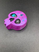 Load image into Gallery viewer, Inspired by nature, this skull statuette is full of shimmery metallic, and vibrant colors and intricate details. The metallic violet color reminds me of sundown, when the sky is illuminating from blue to purple to black. I painted a moon and stars with a teal/green paint to really create a beautiful contrast against the violet color. The forehead of the skully has a beautiful rainbow hematite star bead.
