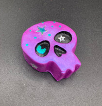 Load image into Gallery viewer, Inspired by nature, this skull statuette is full of shimmery metallic, and vibrant colors and intricate details. The metallic violet color reminds me of sundown, when the sky is illuminating from blue to purple to black. I painted a moon and stars with a teal/green paint to really create a beautiful contrast against the violet color. The forehead of the skully has a beautiful rainbow hematite star bead.