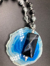 Load image into Gallery viewer, This black agate natural stone necklace features a unique rectangular pyramid shape and multi-colored glass beads. Perfect for all kinds of looks, from cocktail attire to shabby chic to elegant goth styles, this necklace is as versatile as it is stylish and will complete any outfit. The set includes matching earrings, making it a must-have addition to any jewelry collection. Measurements: Necklace is 18 1/2”