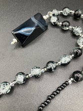 Load image into Gallery viewer, This black agate natural stone necklace features a unique rectangular pyramid shape and multi-colored glass beads. Perfect for all kinds of looks, from cocktail attire to shabby chic to elegant goth styles, this necklace is as versatile as it is stylish and will complete any outfit. The set includes matching earrings, making it a must-have addition to any jewelry collection. Measurements: Necklace is 18 1/2”