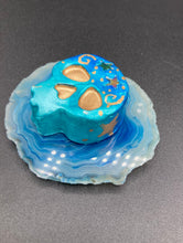 Load image into Gallery viewer, Perfect item to add to your fridge, locker, cubicle, toolbox or dishwasher. This handcrafted skull statuette features shimmering metallic and vivid blue hues, metallic gold stars, and intricate detailing. The skull's forehead is adorned with a glittering hematite star bead.  Measurements: H 1 1/2” x W 1 1/2” x D 3/4”