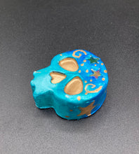 Load image into Gallery viewer, Perfect item to add to your fridge, locker, cubicle, toolbox or dishwasher. This handcrafted skull statuette features shimmering metallic and vivid blue hues, metallic gold stars, and intricate detailing. The skull's forehead is adorned with a glittering hematite star bead.  Measurements: H 1 1/2” x W 1 1/2” x D 3/4”