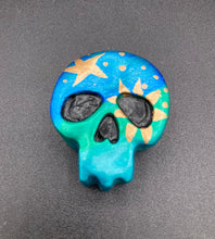 Load image into Gallery viewer, Inspired by nature, this skull statuette is full of vibrant colors and intricate details. The ombre colors from red, to light pink was inspired by the summer sky at sundown that I see all too often. I really wanted to capture those beautiful colors and added metallic gold moon and stars silhouettes to tie it all together.