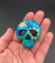 Load image into Gallery viewer, Inspired by nature, this skull statuette is full of vibrant colors and intricate details. The ombre colors from red, to light pink was inspired by the summer sky at sundown that I see all too often. I really wanted to capture those beautiful colors and added metallic gold moon and stars silhouettes to tie it all together.