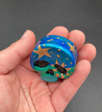 Load image into Gallery viewer, Inspired by nature, this skull statuette is full of vibrant colors and intricate details. The ombre colors from red, to light pink was inspired by the summer sky at sundown that I see all too often. I really wanted to capture those beautiful colors and added metallic gold moon and stars silhouettes to tie it all together.