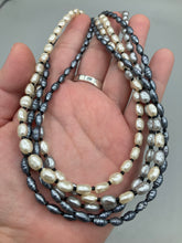 Load image into Gallery viewer, This necklace boasts five strands of varying shades of white and gray faux baroque pearls, as well as a selection of black glass beads. Measurements: Necklace is 16 1/2" in length and can be adjusted to 18"