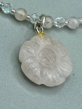 Load image into Gallery viewer, This elegant necklace is adorned with a beautiful rose quartz pendant featuring an intricate floral cutout, complemented by small round rose quartz beads with an iridescent glass finish. Measurements: Necklace is 18 1/2”