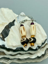 Load image into Gallery viewer, This set of earrings features a cylinder bone bead and round bone bead with eye design and a gold-tone glass bead. Neutral colors allow for versatile styling; the resulting look is sure to be unique.  Measurements: 1 1/2 ” in length