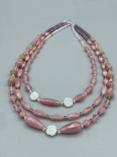 Load image into Gallery viewer, This three-strand beaded necklace is crafted with iridescent dusty rose glass, along with white, gold, pink, and iridescent purple beads for an eclectic mix of colors, tones, and textures. Perfect for any occasion, this gorgeous statement piece will add the finishing touch to your look. Measurements: Necklace is 17” in length, can be adjusted up to 19"