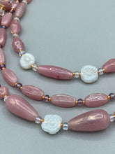 Load image into Gallery viewer, This three-strand beaded necklace is crafted with iridescent dusty rose glass, along with white, gold, pink, and iridescent purple beads for an eclectic mix of colors, tones, and textures. Perfect for any occasion, this gorgeous statement piece will add the finishing touch to your look. Measurements: Necklace is 17” in length, can be adjusted up to 19"