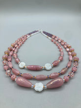 Load image into Gallery viewer, This three-strand beaded necklace is crafted with iridescent dusty rose glass, along with white, gold, pink, and iridescent purple beads for an eclectic mix of colors, tones, and textures. Perfect for any occasion, this gorgeous statement piece will add the finishing touch to your look. Measurements: Necklace is 17” in length, can be adjusted up to 19"