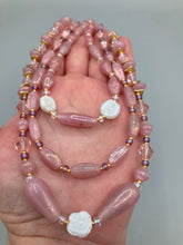 Load image into Gallery viewer, This three-strand beaded necklace is crafted with iridescent dusty rose glass, along with white, gold, pink, and iridescent purple beads for an eclectic mix of colors, tones, and textures. Perfect for any occasion, this gorgeous statement piece will add the finishing touch to your look. Measurements: Necklace is 17” in length, can be adjusted up to 19"