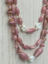 Load image into Gallery viewer, This three-strand beaded necklace is crafted with iridescent dusty rose glass, along with white, gold, pink, and iridescent purple beads for an eclectic mix of colors, tones, and textures. Perfect for any occasion, this gorgeous statement piece will add the finishing touch to your look. Measurements: Necklace is 17” in length, can be adjusted up to 19"