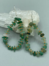 Load image into Gallery viewer, Elegant hoop earrings featuring natural green aventurine stone chips and gold-tinged glass beads. Measurements: 2" length and 1 1/2” in width