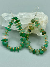 Load image into Gallery viewer, Elegant hoop earrings featuring natural green aventurine stone chips and gold-tinged glass beads. Measurements: 2" length and 1 1/2” in width