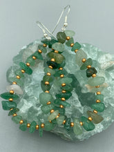 Load image into Gallery viewer, Elegant hoop earrings featuring natural green aventurine stone chips and gold-tinged glass beads. Measurements: 2" length and 1 1/2” in width