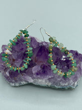Load image into Gallery viewer, Elegant hoop earrings featuring natural green aventurine stone chips and gold-tinged glass beads. Measurements: 2" length and 1 1/2” in width