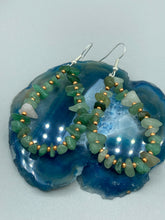 Load image into Gallery viewer, Elegant hoop earrings featuring natural green aventurine stone chips and gold-tinged glass beads. Measurements: 2" length and 1 1/2” in width